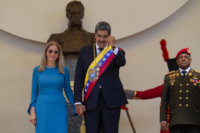 Venezuelan President Nicolas Maduro and his wife Cilia Flores stand at the National Assembly after his swearing-in ceremony for a third term in Caracas, Venezuela, Friday, Jan. 10, 2025. (AP Photo/Ariana Cubillos)