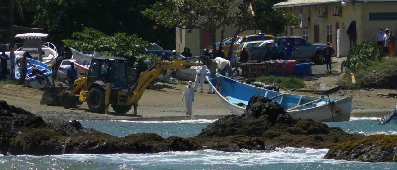 Las autoridades sacan del mar un cayuco encontrado con 14 cuerpo en la playa de Belle Garden, en la isla caribeña de Tobago, el 28 de mayo de 2021..