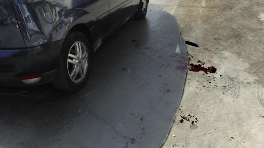 Sangre del herido junto al coche en el que fue evacuado