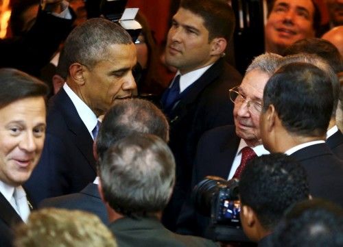 U.S. President Barack Obama talks with his Cuban counterpart Raul Castro before the inauguration of the VII Summit of the Americas in Panama City