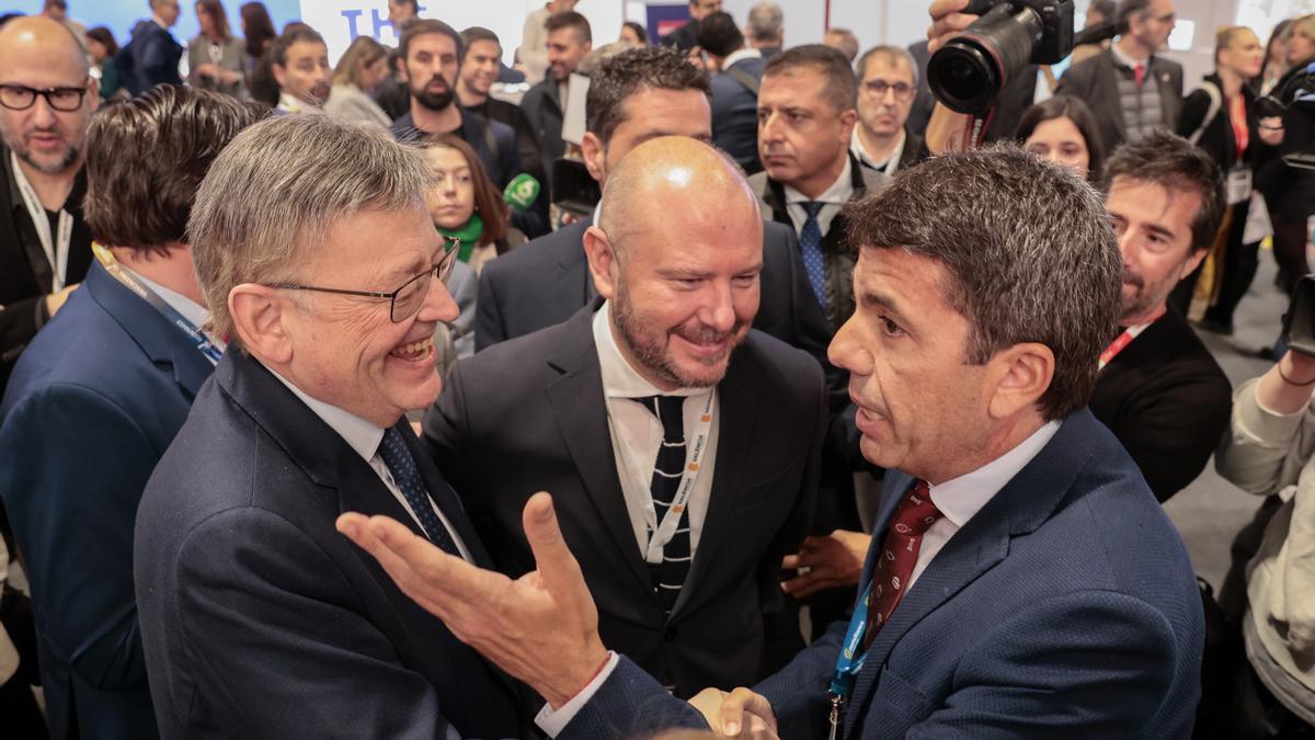 El president de la Generalitat, Ximo Puig, y el candidato del PPCV, Carlos Mazón, hablan en una visita en Fitur.
