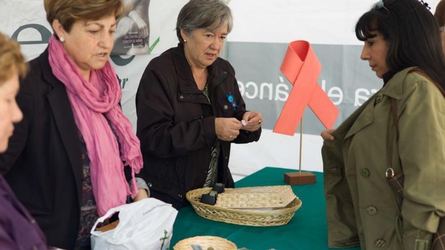 Voluntarias de la AECC de Benavente, en una mesa informativa. | E. P.