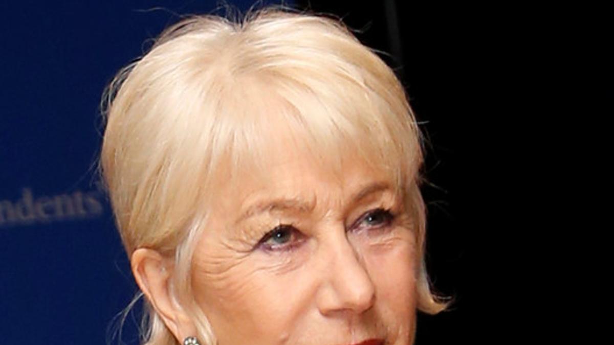 Actress Helen Mirren points to a &quot;Prince&quot; symbol she is wearing as she arrives on the red carpet for the annual White House Correspondents Association Dinner in Washington