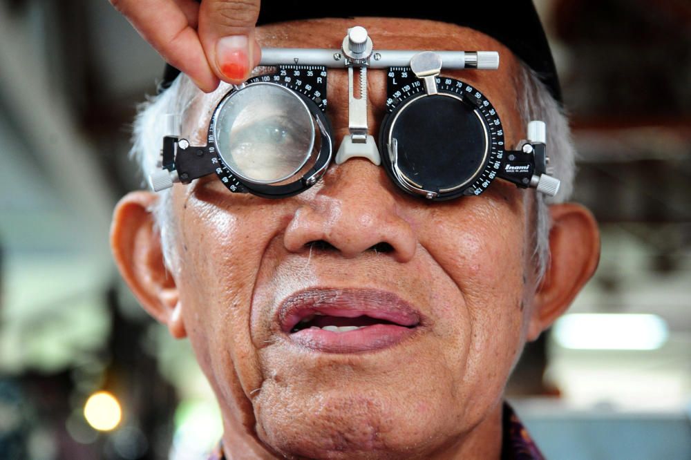 A man has his eyes checked at a government ...