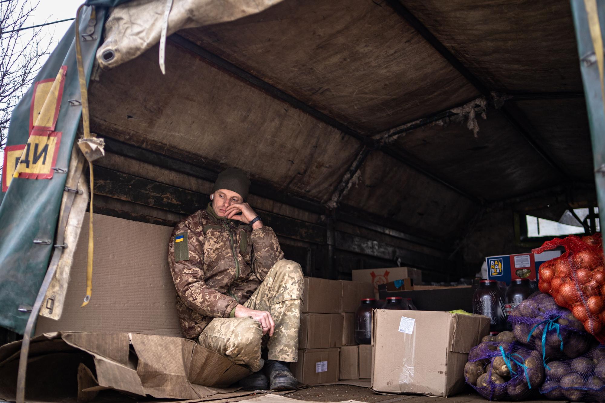 Un soldado ucraniano vigila un camión que suministra alimentos al frente.