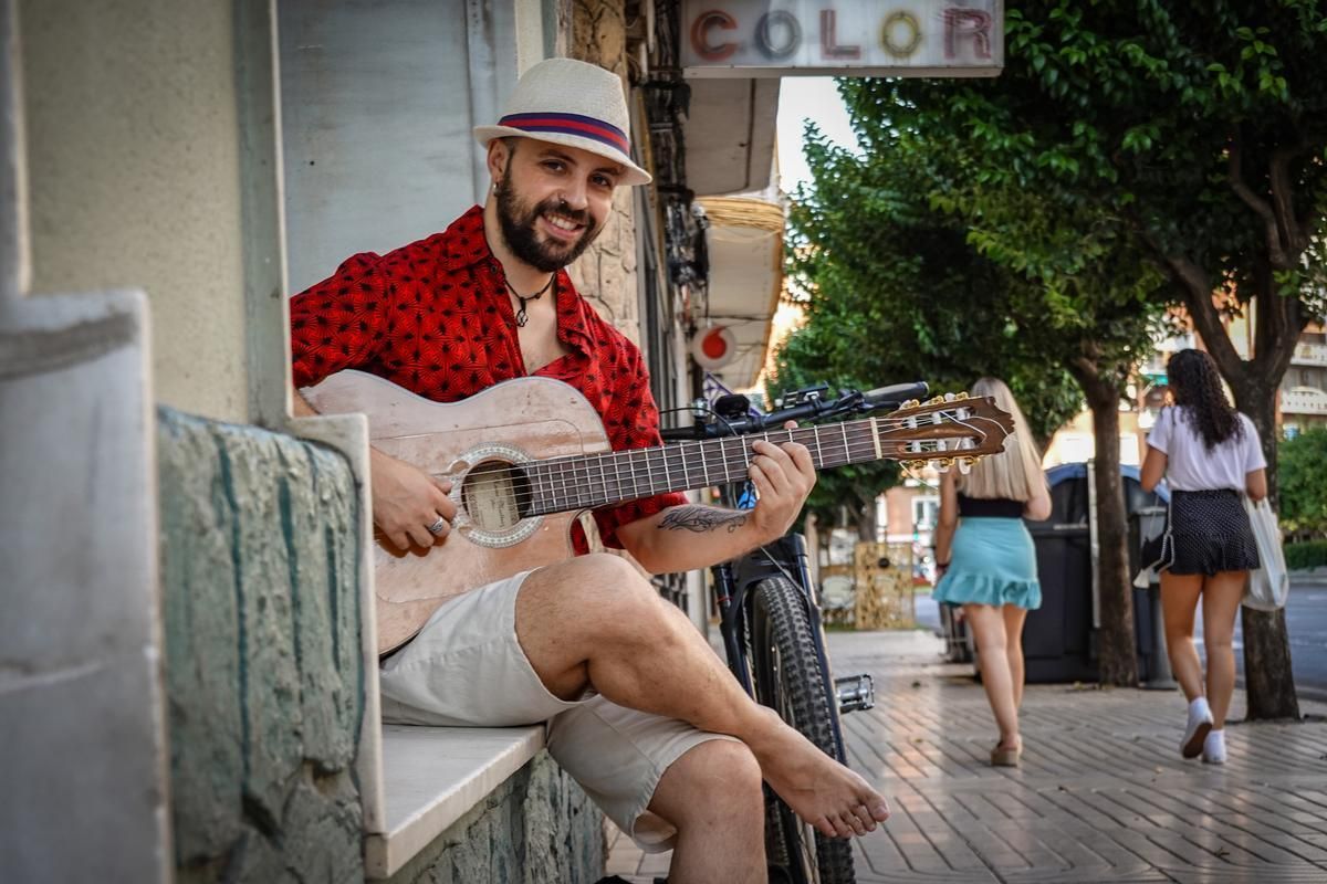 El músico y compositor Willy Wylazo, con su guitarra en una calle pacense.