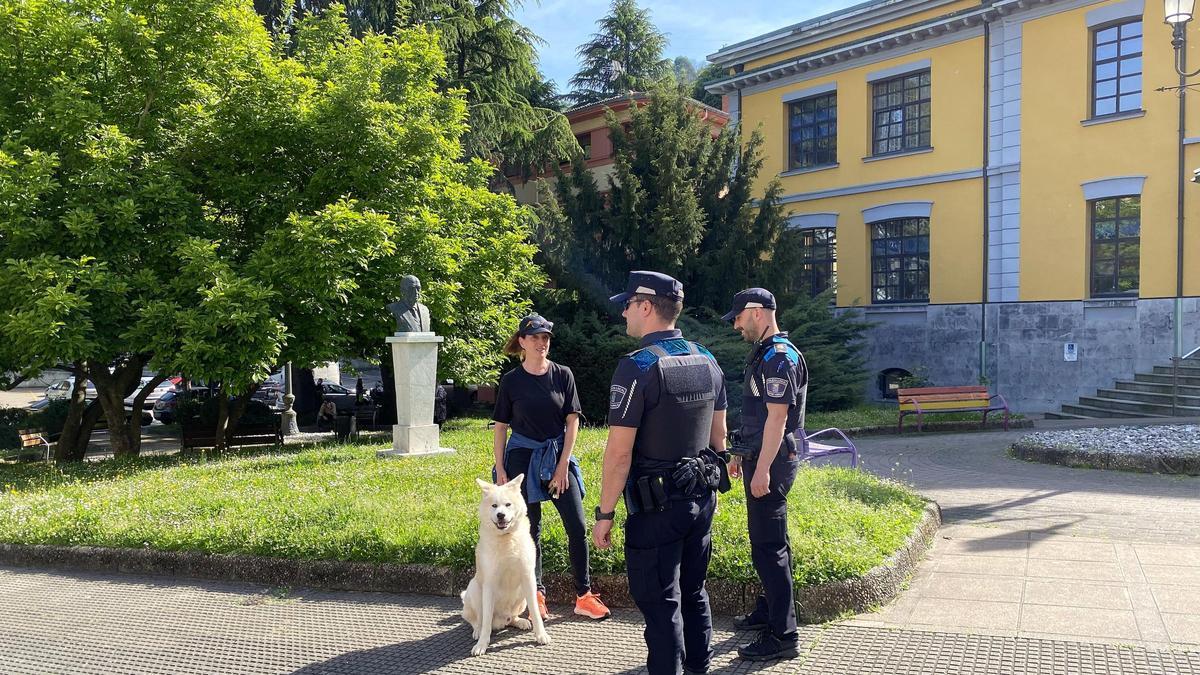 Dos agentes de la Policía Local de San Martín coversan con la propietaria de un perro en Sotrondio