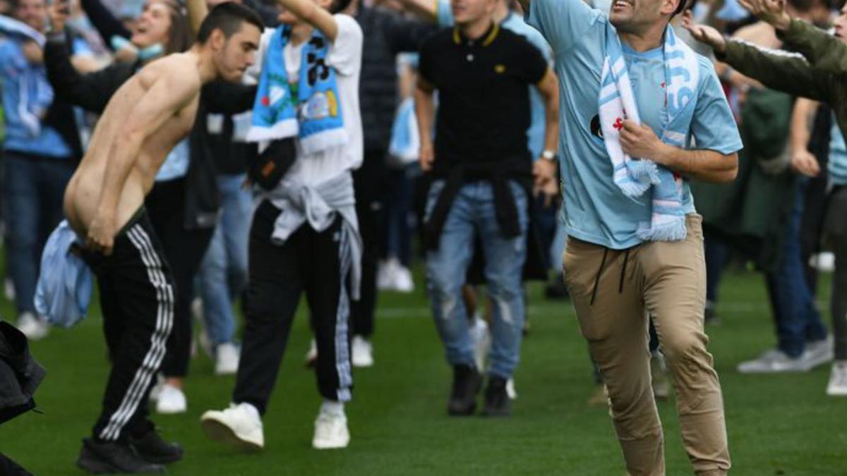 Aficionados del Celta en el césped y un policía durante la invasión de campo. |  // ARCAY / ROLLER AGENCIA