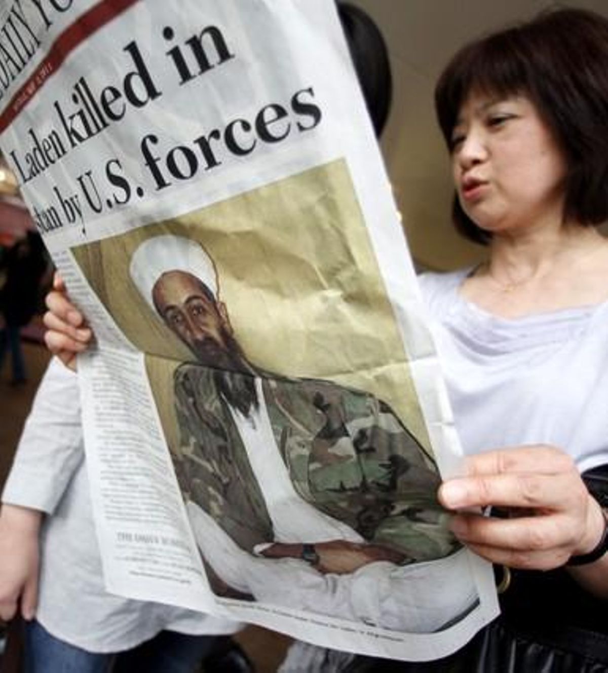 Una dona llegeix una edició especial d’un diari japonès amb motiu de la mort de Bin Laden. Tòquio.