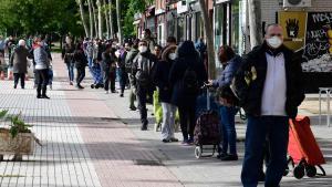 Varias personas se unen a las ’colas del hambre’ de Aluche para recoger comida, en mayo de 2020.