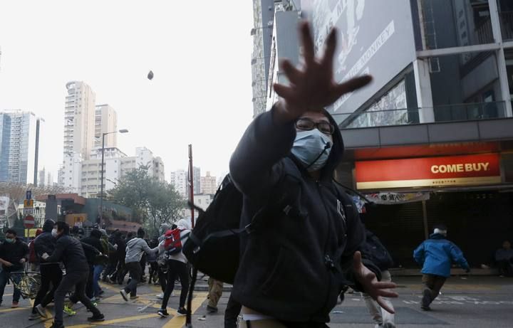 Protesters throw bricks during a clash with riot police at Mongkok district in Hong Kong