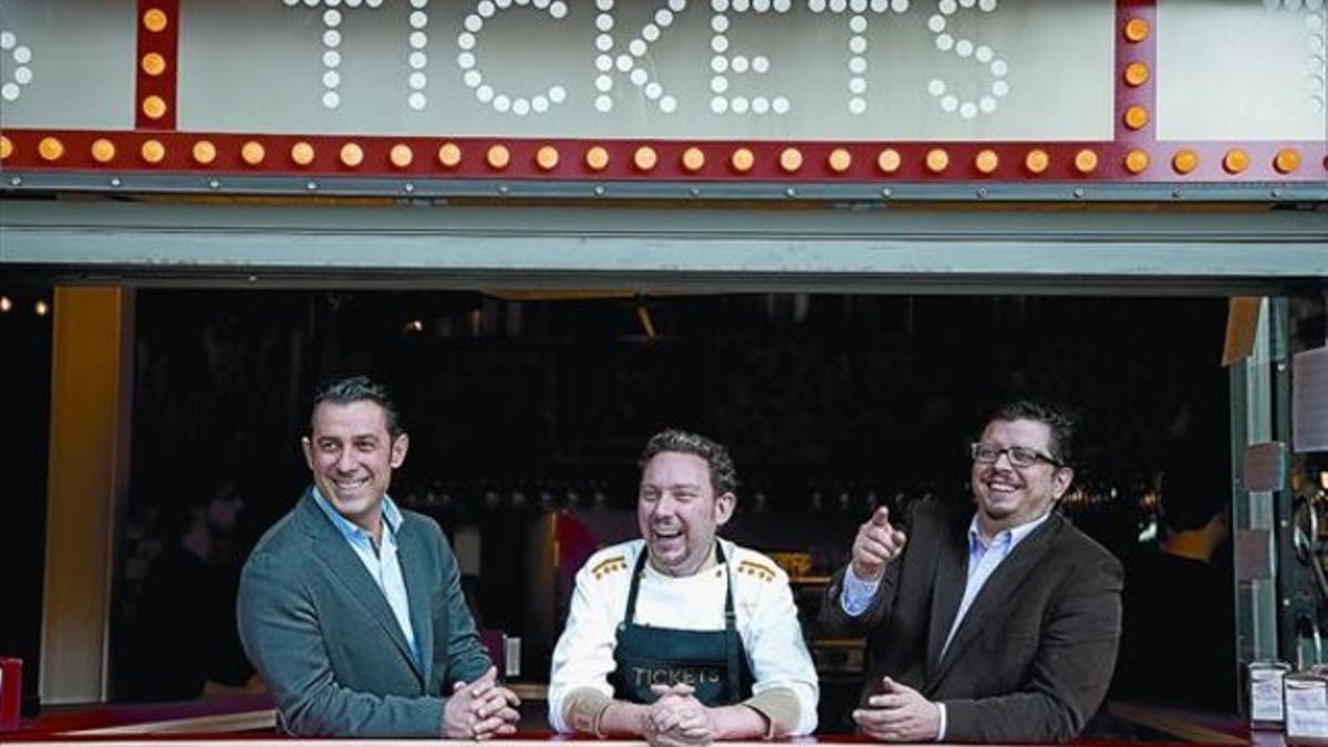 Los hermanos Borja y Juan Carlos Iglesias flanquean a Albert Adrià, ayer, en la barra del restaurante Tickets que da a la calle.