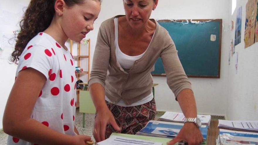 María Dolores Antón y Cecilia Vallina, recogiendo libros en el banco.