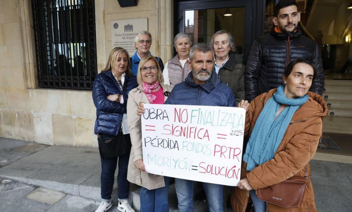 Vecinos de Portuarios con una pancarta a las puertas del Ayuntamiento. | ÁNGEL GONZÁLEZ