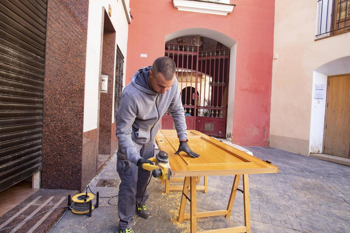 Un carpintero ultima la mejora de una puerta de una vivienda, en imagen de archivo.