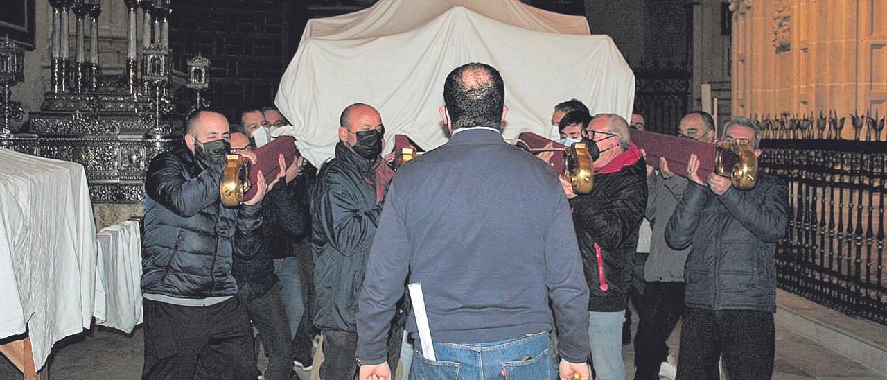 El capataz Javier Fábrega, de espaldas, dirige el ensayo de los costaleros del  trono de Jesús Resucitado por el interior de San Patricio.