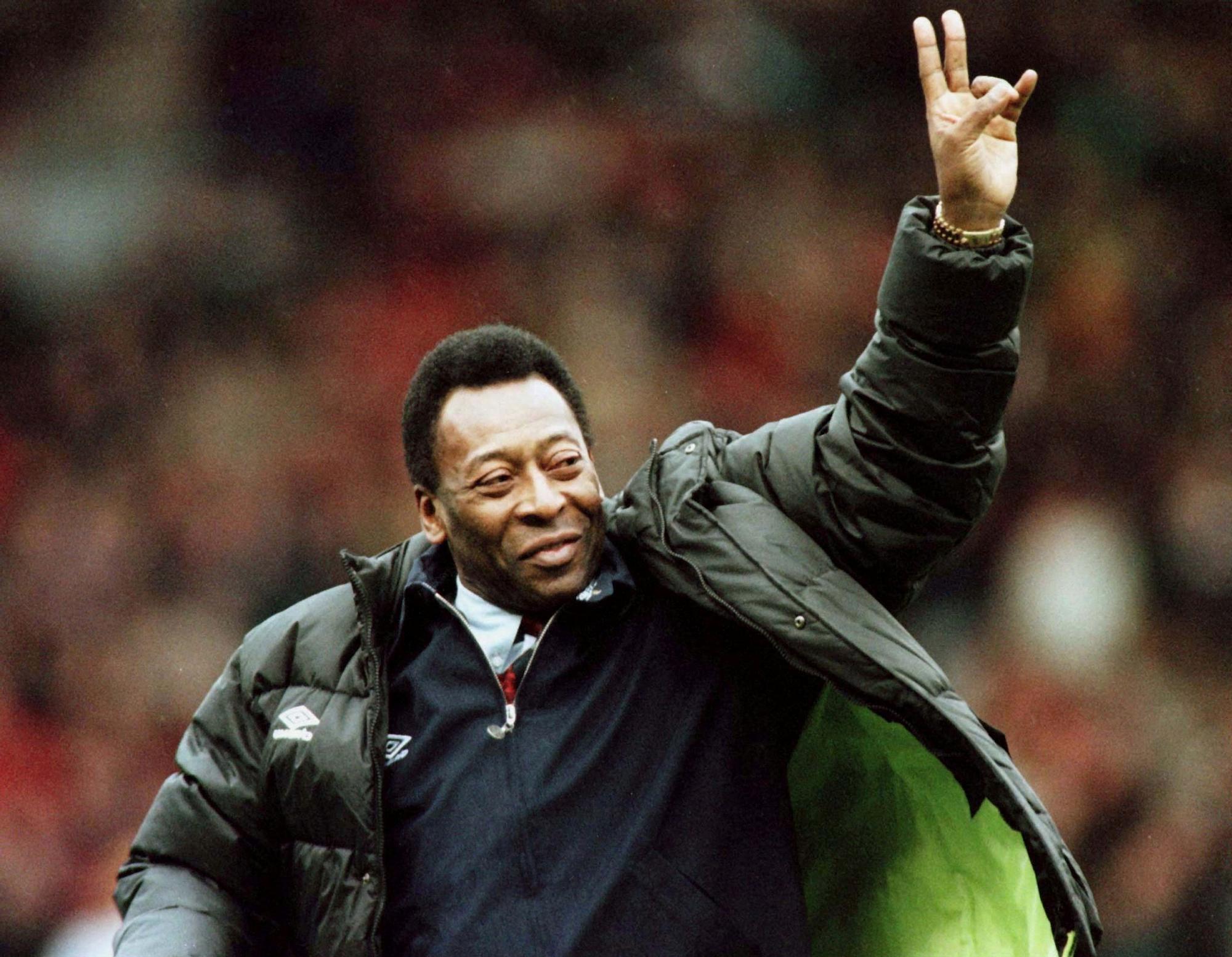 FILE PHOTO: Brazilian soccer legend Pele greets the crowd at the Manchester United versus Liverpool match during the half time interval in Manchester