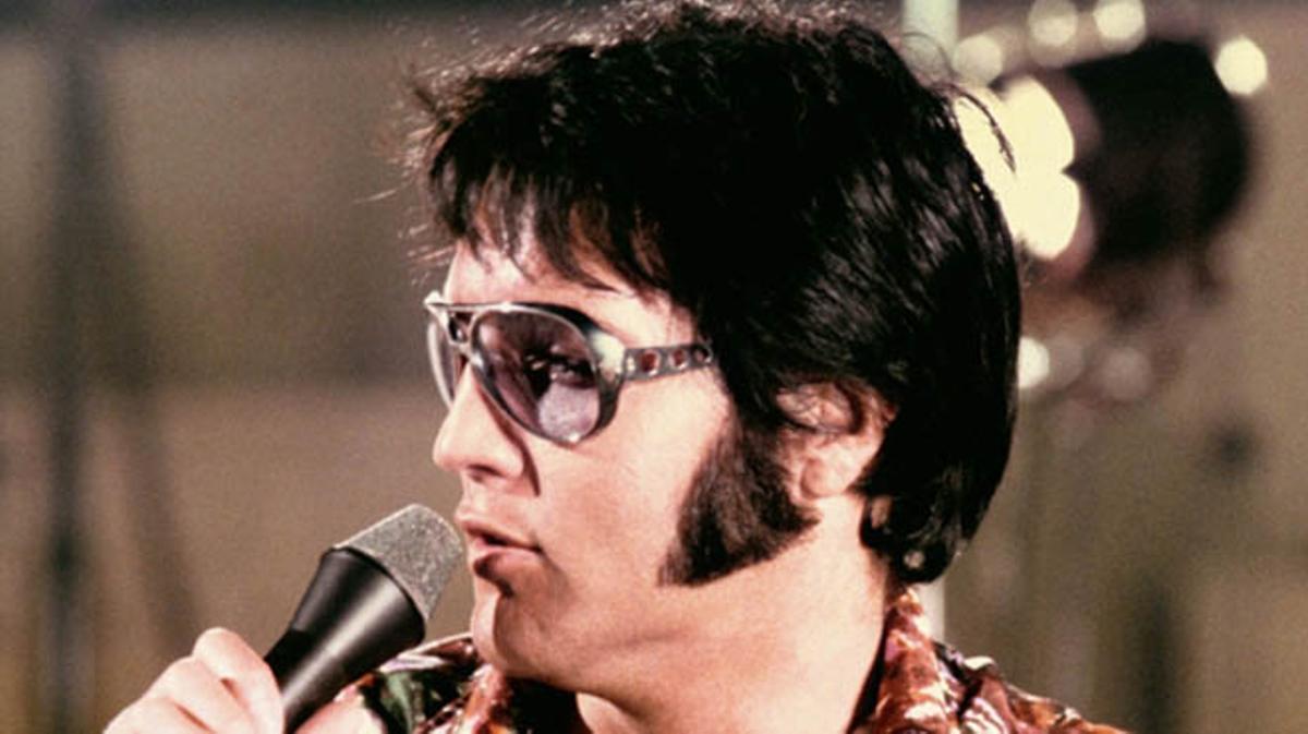 Elvis Presley, cantant {’Just} {can’t} help {believin}’’.