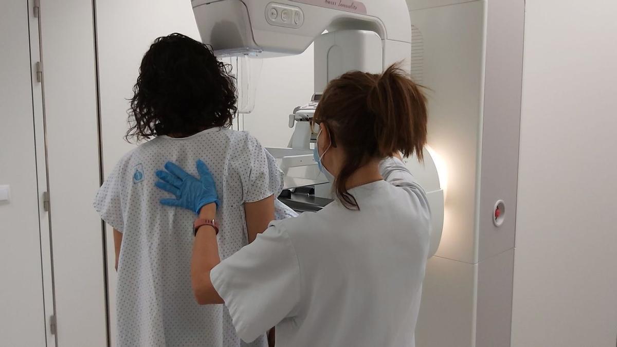 Una dona sotmetent-se a una mamografia