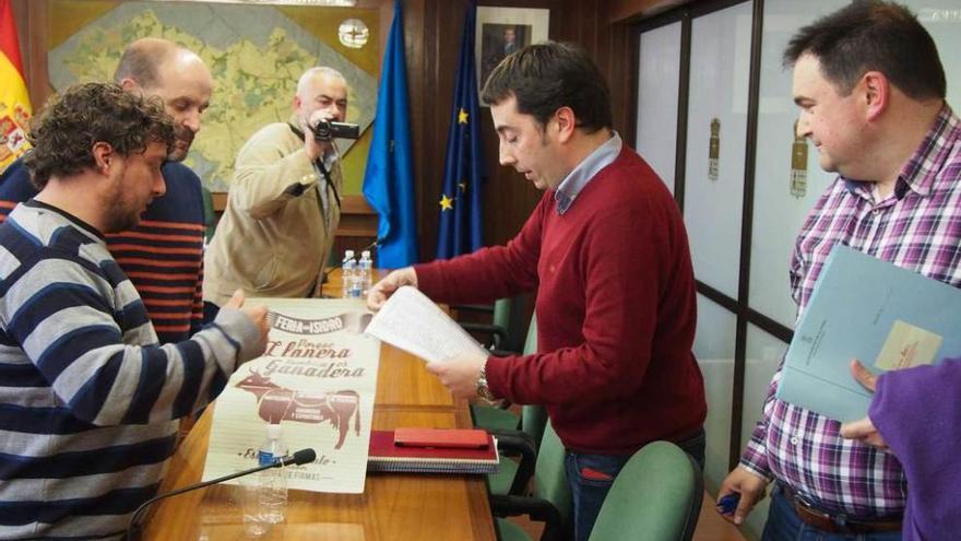 Los ganaderos Antonio Fernández y José Herminio Suárez, entregando las firmas a Gerardo Sanz, ayer, tras el Pleno en Posada.