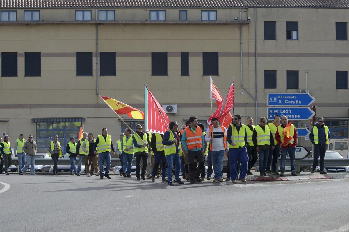 Un grupo de agricultores y ganaderos caminando hacia la autovía A-6 antes del corte.