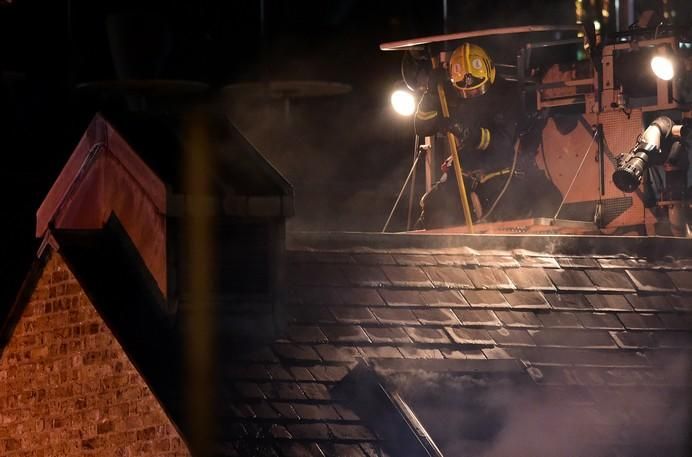 A firefighter tackles a fire at Camden Market in ...