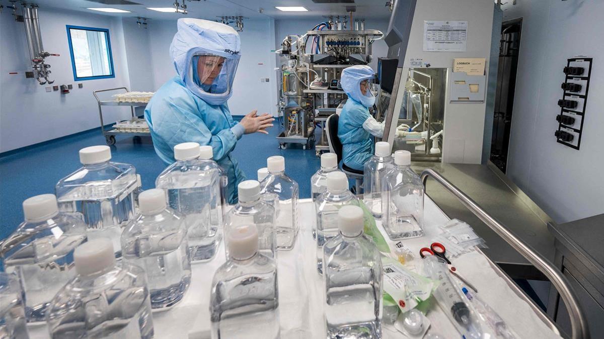 CORRECTION   Employees in cleanroom suits test the procedures for the manufacturing of the messenger RNA (mRNA) for the Covid-19 vaccine at the new manufacturing site of German company BioNTech on March 27  2021 in Marburg  central Germany  - German firm BioNTech said on March 30  2021 it was on track to manufacture 2 5 billion doses of its Covid-19 vaccine this year with US partner Pfizer  25 percent more than previously expected  (Photo by Thomas Lohnes   AFP)    The erroneous mention s  appearing in the metadata of this photo by Thomas Lohnes has been modified in AFP systems in the following manner   ---  instead of  ---   Please immediately remove the erroneous mention s  from all your online services and delete it (them) from your servers  If you have been authorized by AFP to distribute it (them) to third parties  please ensure that the same actions are carried out by them  Failure to promptly comply with these instructions will entail liability on your part for any continued or post notification usage  Therefore we thank you very much for all your attention and prompt action  We are sorry for the inconvenience this notification may cause and remain at your disposal for any further information you may require