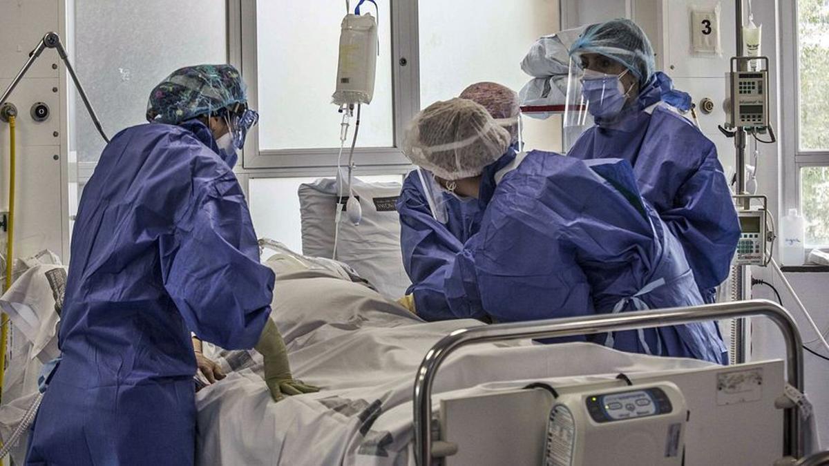Unos sanitarios atienden a un enfermo de coronavirus en un hospital.