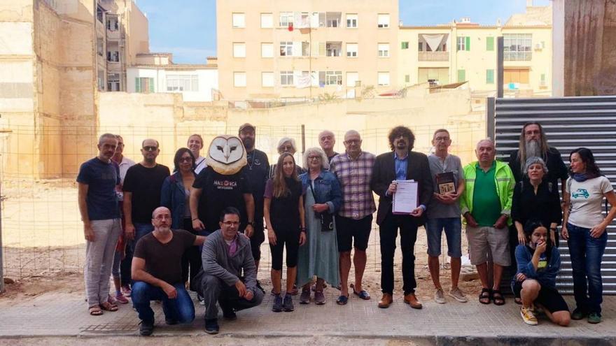 La asociación Amics de la Casa del Poble posa ante el solar.