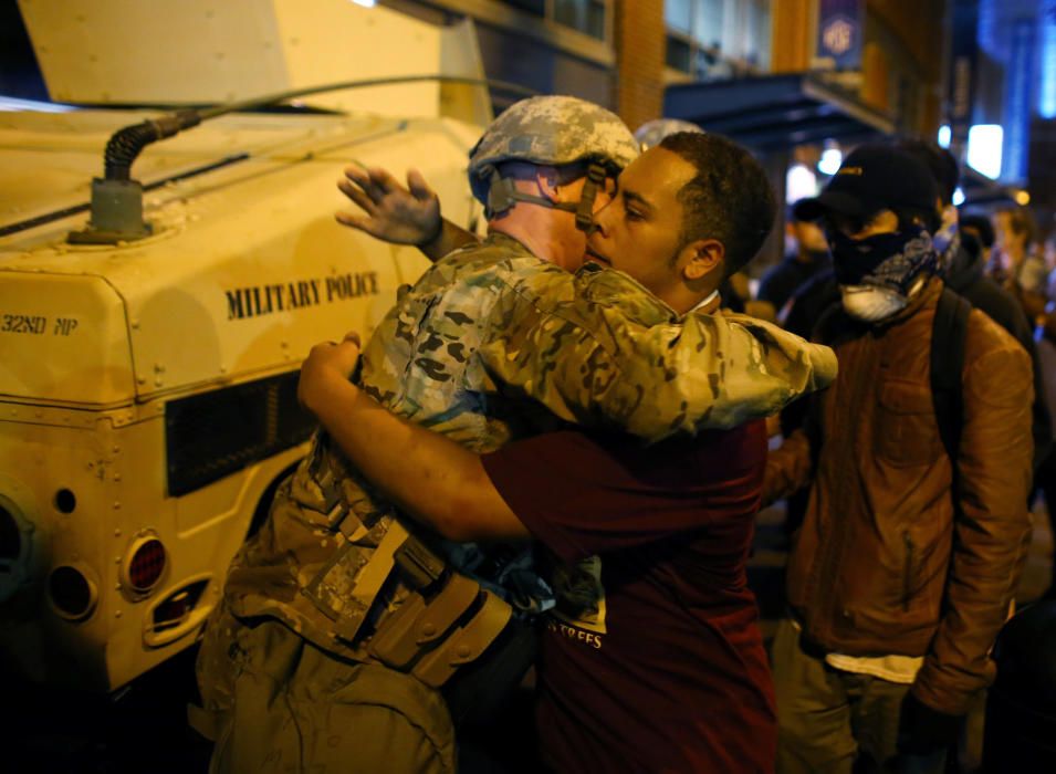 A U.S. National guard soldier accepts a hug from ...