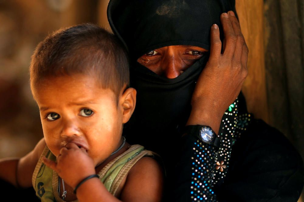 Rohingya refugee cries next to her son, outside ...