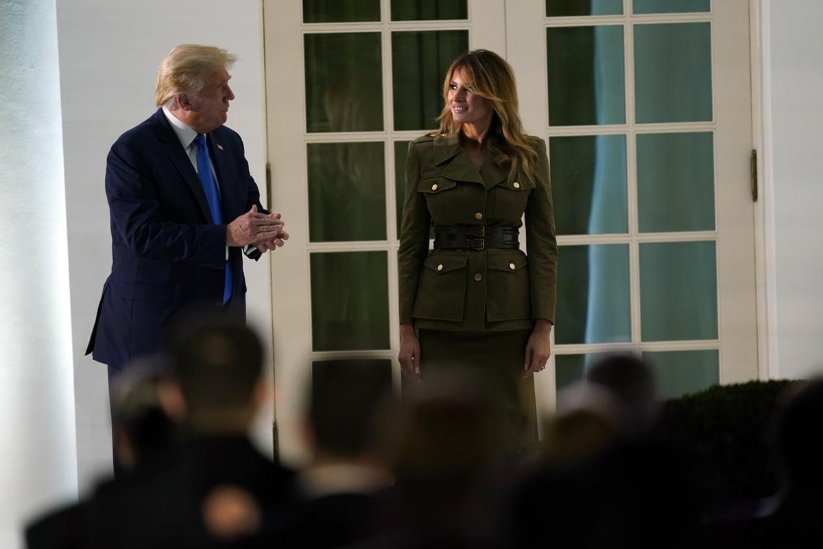 President Donald Trump joins first lady Melania Trump on stage after her speech to the 2020 Republican National Convention from the Rose Garden of the White House, Tuesday, Aug. 25, 2020, in Washington. (AP Photo/Evan Vucci)