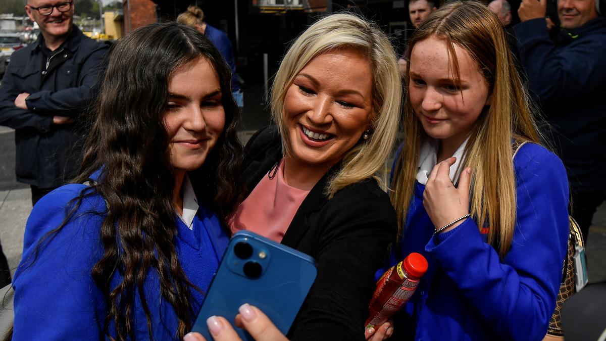 La candidata del Sinn Féin a las elecciones de Irlanda del Norte, Michelle O'Neill, se hace un 'selfie' con unas estudiantes, este lunes.