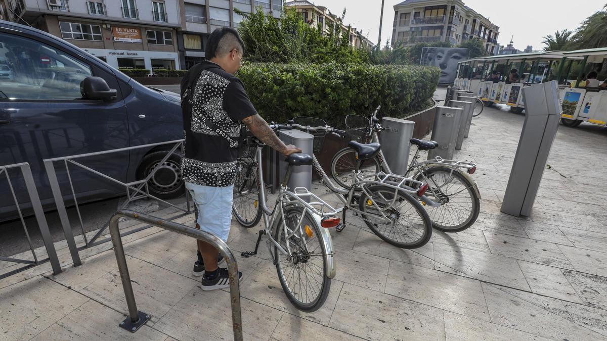 Un usuario de BiciElx coge una bicicleta en pleno centro de Elche
