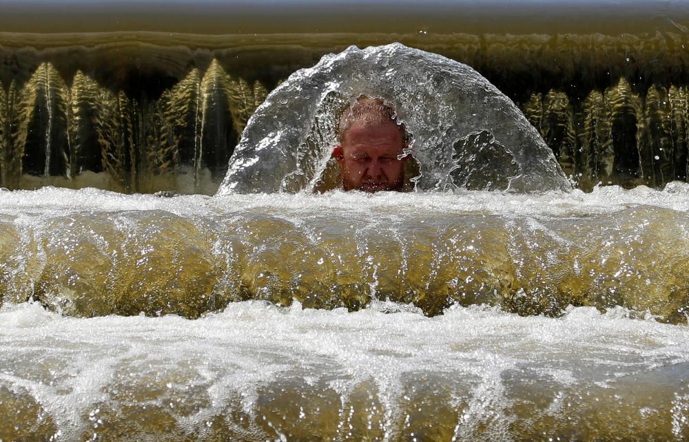 A man cools off in the Berounka river in ...