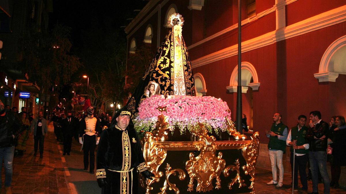 La Virgen de la Soledad, del Paso Negro, por la carrera secundaria camino de la arteria principal para procesionar el Domingo de Ramos.