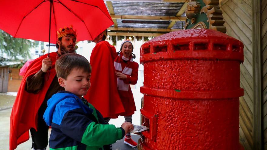 Apurando el envío de cartas a Sus Majestades de Oriente. La Aldea de Nadal de Vilagarcía cerrará hoy sus puertas con numerosas actividades destinadas a los más pequeños. Ayer los elfos de Nelson Quinteiro estuvieron repartiendo entre los viandantes paraguas de la campaña promocional “Son da Casa!” y varios niños depositaron sus cartas dirigidas a Melchor, Gaspar y Baltasar en el buzón rojo que está colocado en la plaza de Independencia. | IÑAKI ABELLA