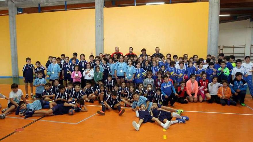 Entrenadores y jugadores de Teucro y Cangas, junto a los niños de la base. // G. Santos