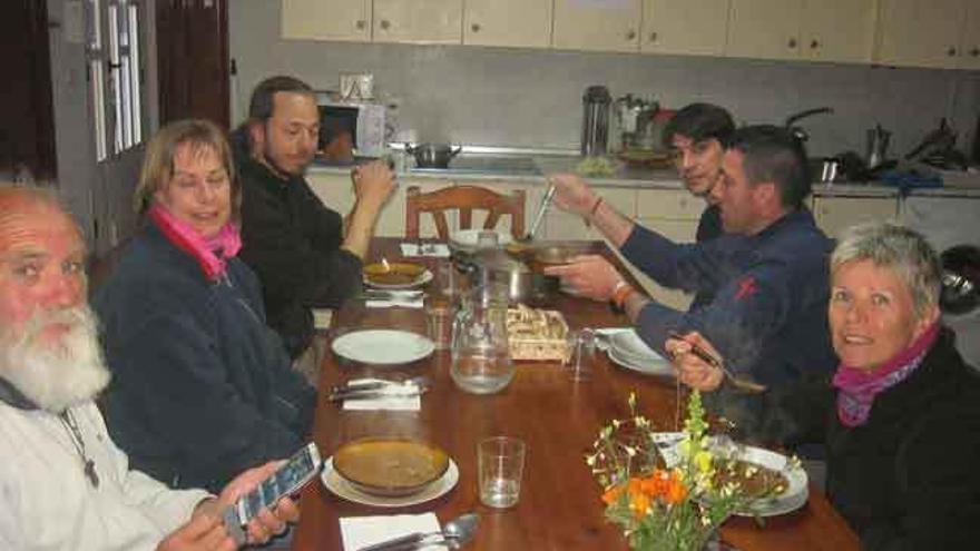 Un grupo de peregrinos comparte la comida en el albergue de Tábara.