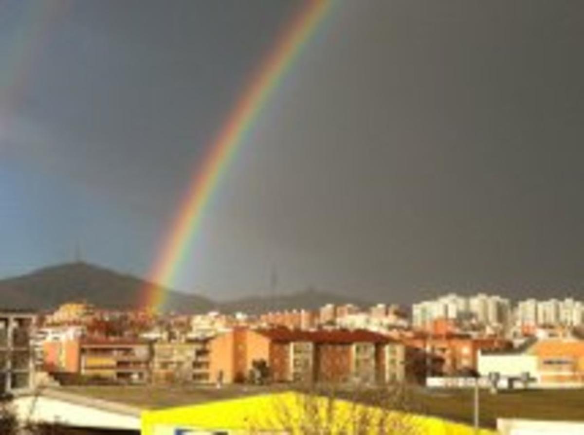 Un preciós arc de Sant Martí per sobre de les teulades de Vallirana.