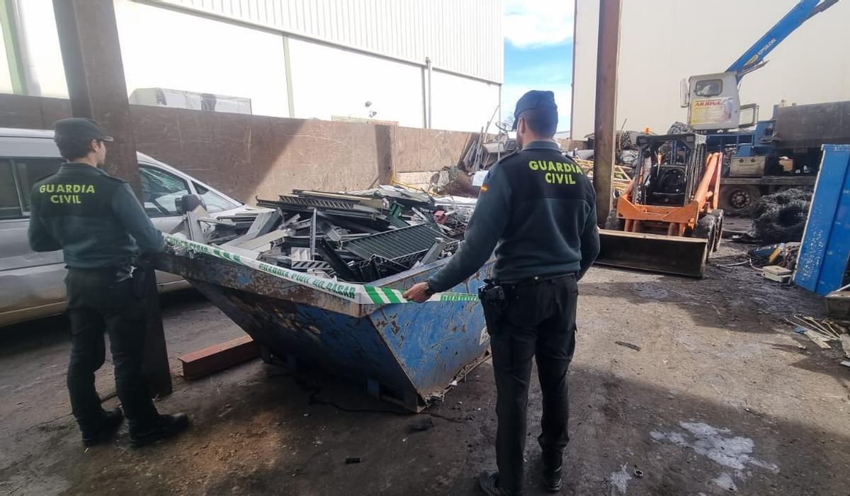 Guardias civiles examinan parte de las persianas robadas que han sido recuperadas.