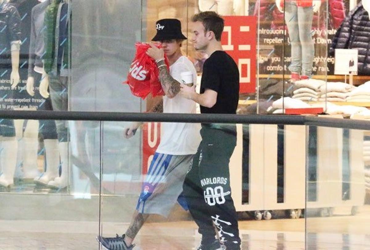 Justin Bieber con bolsas y su amigo con un café