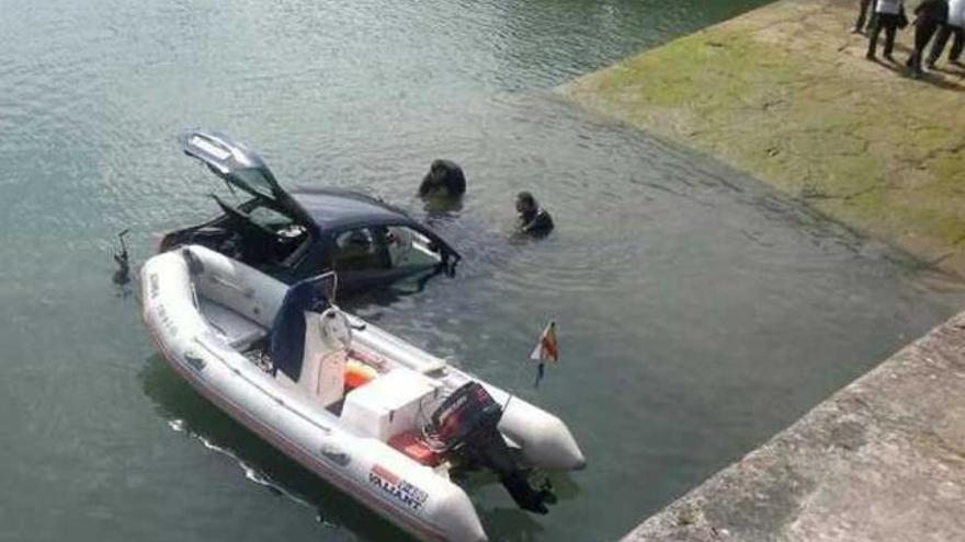 El coche accidentado, semisumergido en las aguas del puerto de El Puntal.