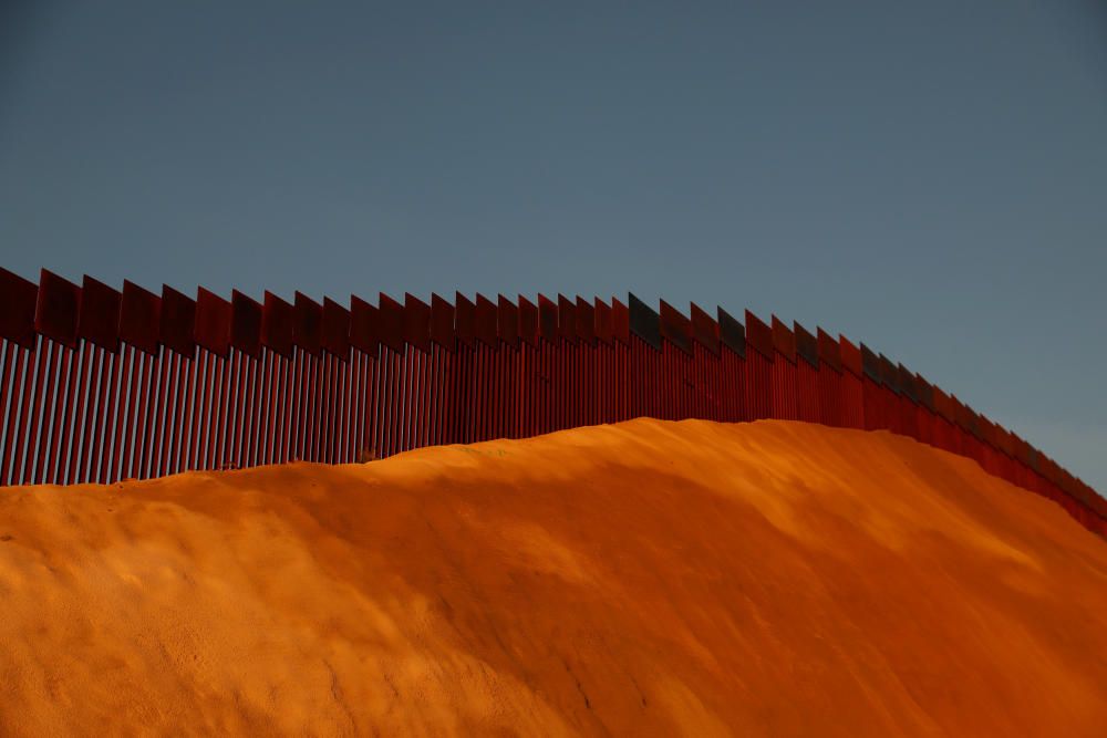 The U.S. and Mexico border fence is seen in ...