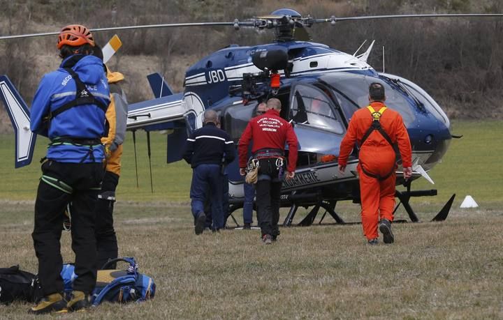 French Alpine rescue units gather on a field as they prepare to reach the crash site of an Airbus A320