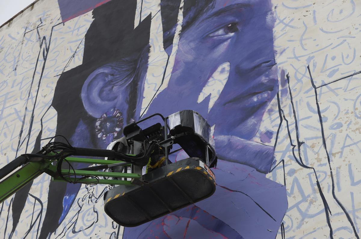 Murfin, en su grúa pintando uno de los murales del barrio, junto a las Bodegas Perdiguer.