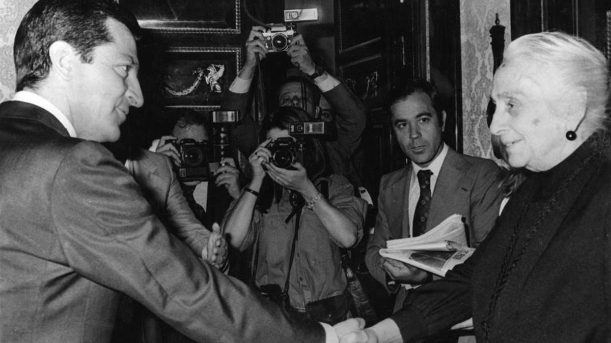 Imagen de archivo del presidente Adolfo Suárez saludando a Dolores Ibárruri, 'la Pasionaria', rodeados de medios gráficos.