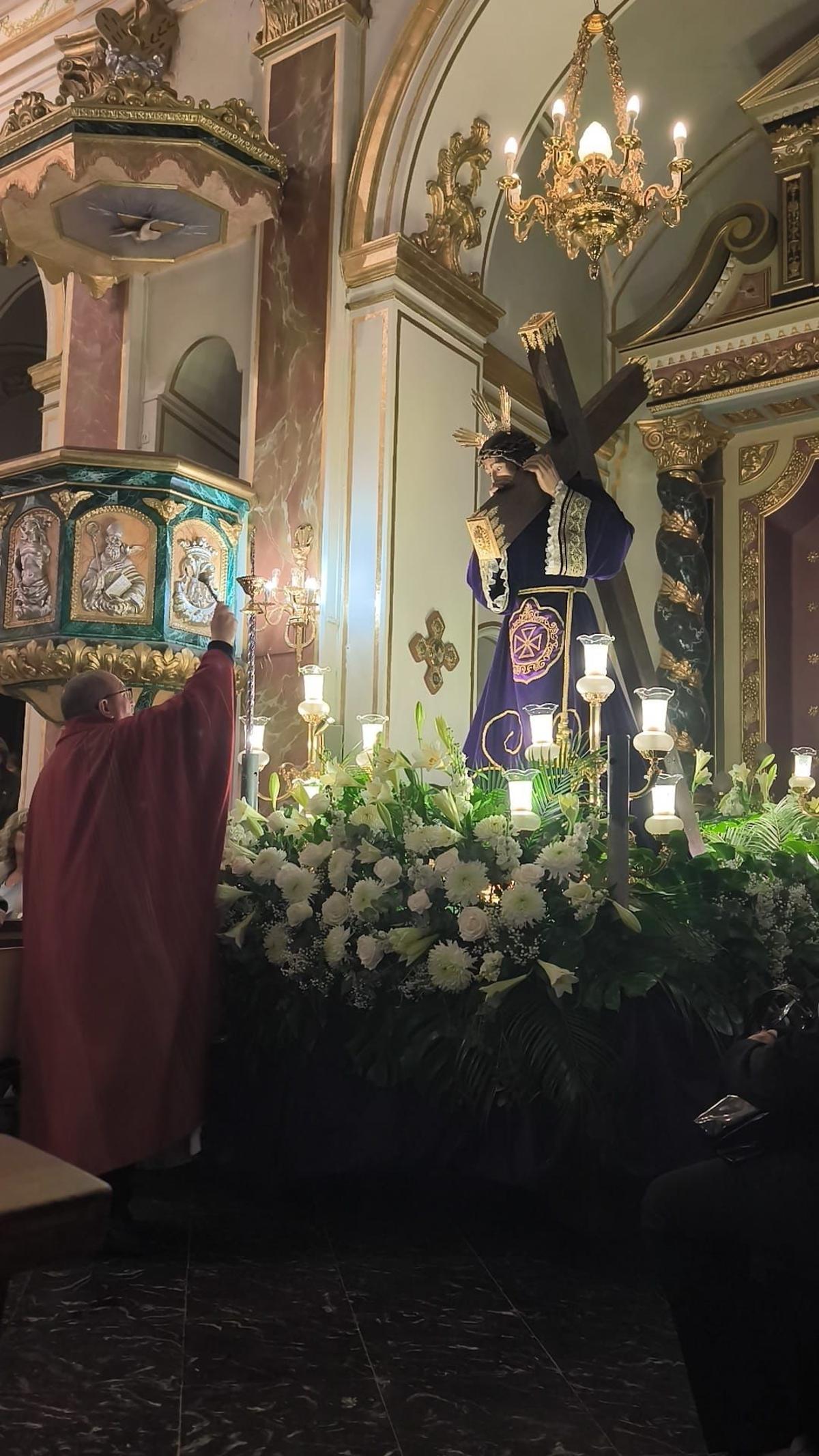 El párroco bendiciendo la imagen.