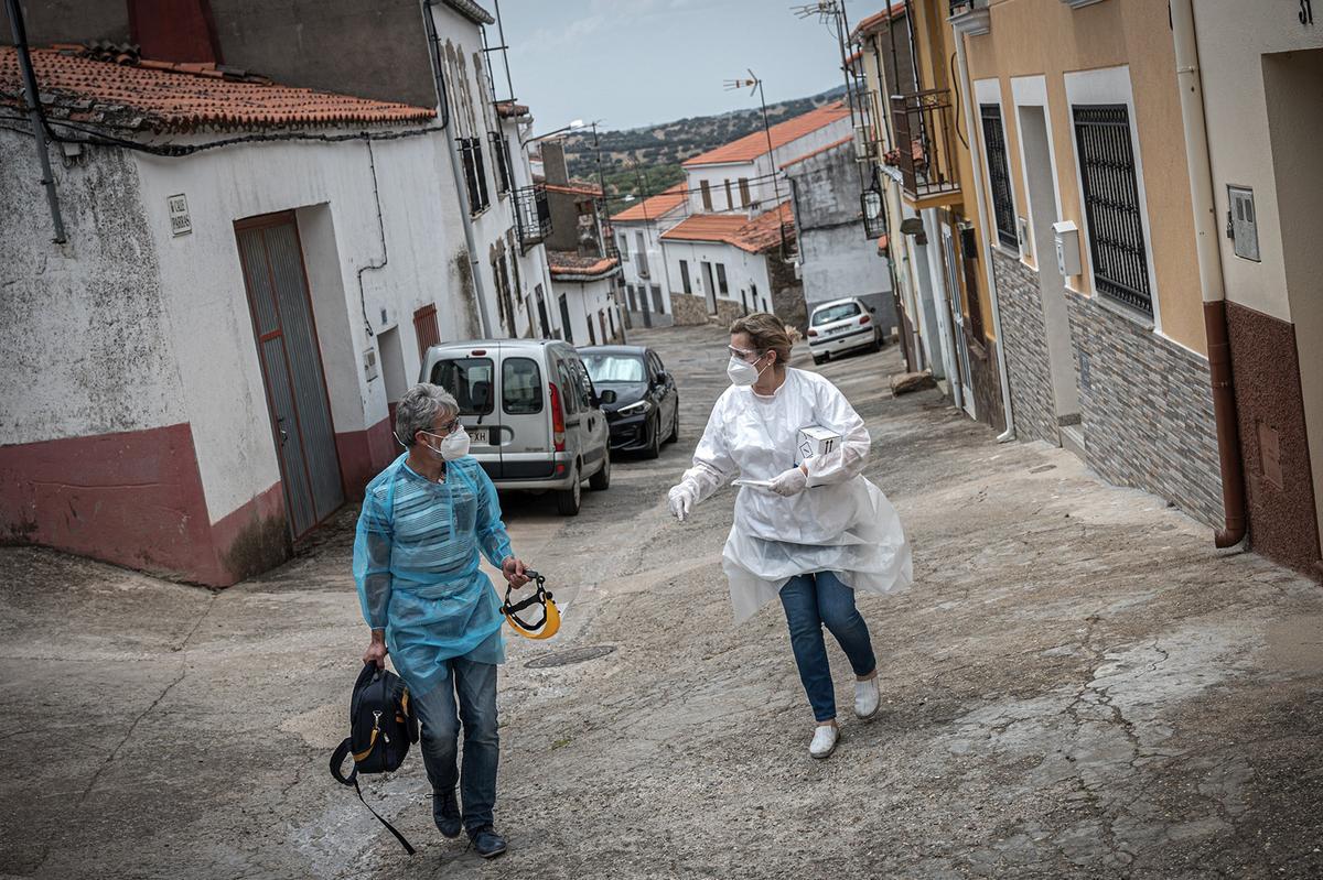 Mar y Enrique son los sanitarios del consultorio de Mirabel, localidad de 660 habitantes. Ella vive en el mismo pueblo, donde trabaja desde hace treinta años. En el brote de coronavirus de Enero se contagiaron más de 40 vecinos, Mar entre ellos. En la imagen, ambos conversan de camino al domicilio de un paciente con síntomas sospechosos.