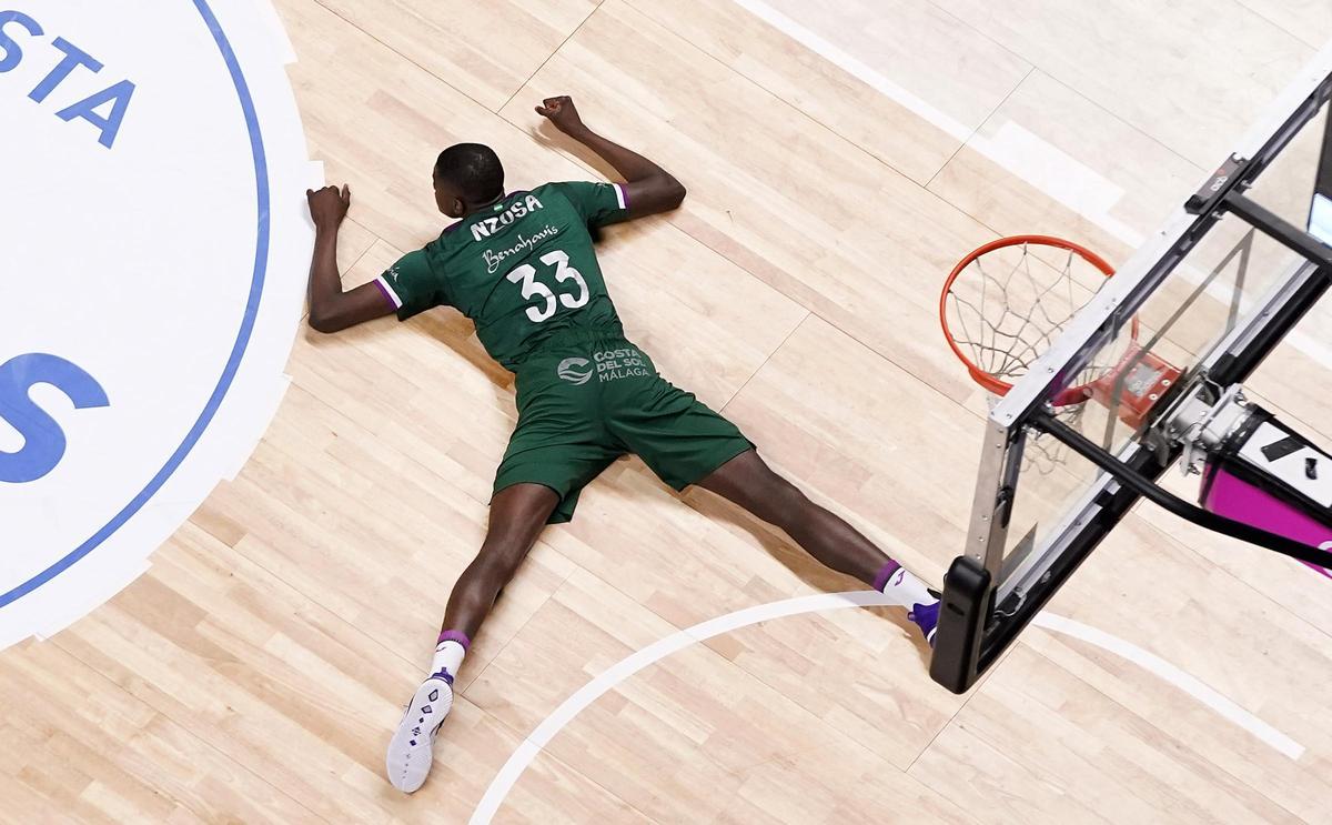 Nzosa, tumbado en la pista, durante su etapa en el Unicaja.